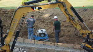 compacting soil behind retaining wall